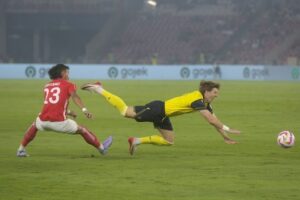 Ole Romeny terjatuh usai berduel dengan Hansamu Yama dalam laga Piala Presiden 2025 Oxford United vs Liga Indonesia All Star di Stadion Utama Gelora Bung Karno, Minggu (6/7/2025). (c) Bola.net/M Iqbal Ichsan