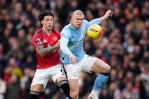 Duel Lisandro Martinez dengan Erling Haaland di laga Manchester United vs Manchester City, Sabtu (17/01/2026). (c) AP Photo/Dave Thompson